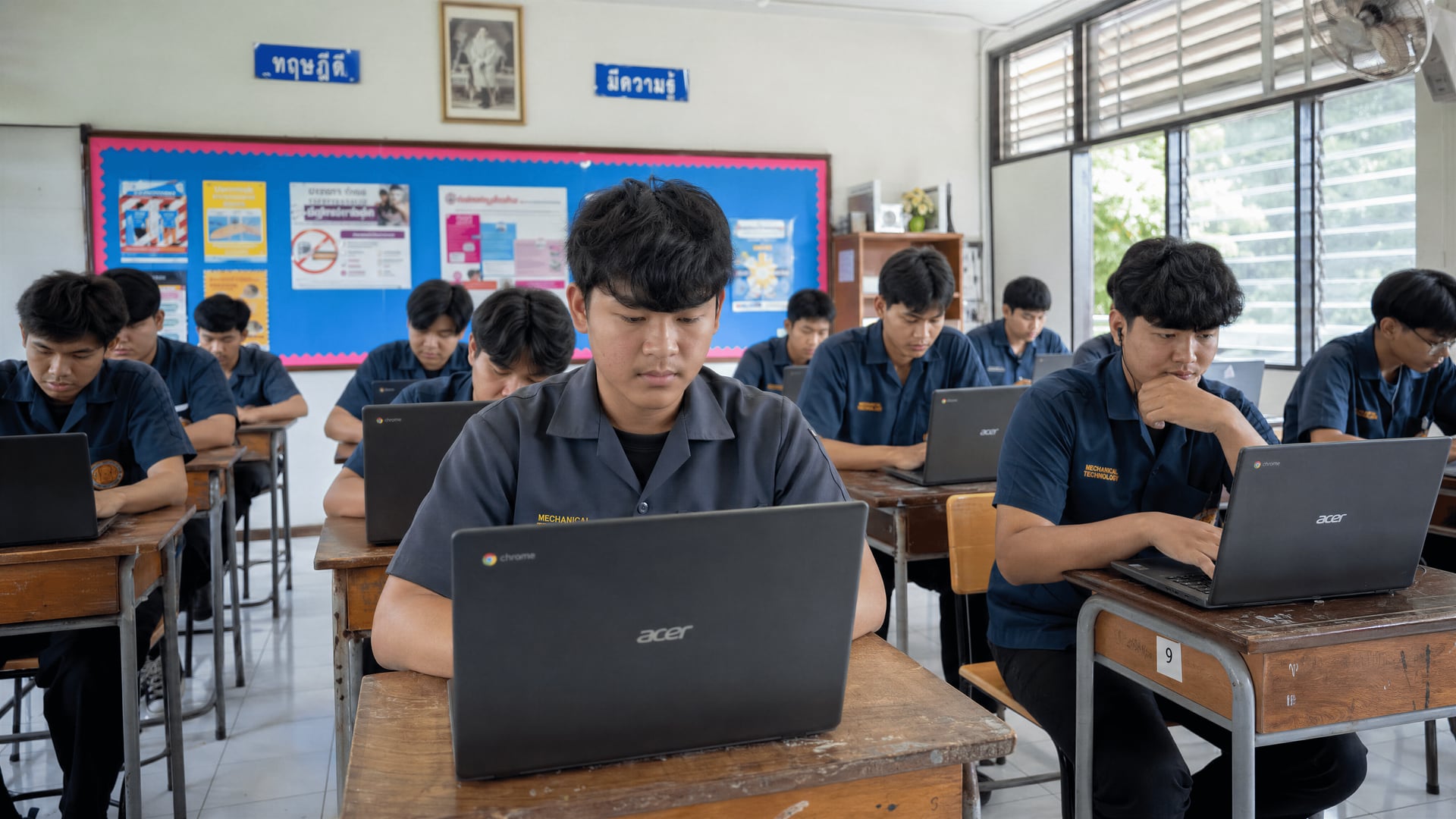 Thai vocational students completing an anonymous online cannabis health survey in a classroom